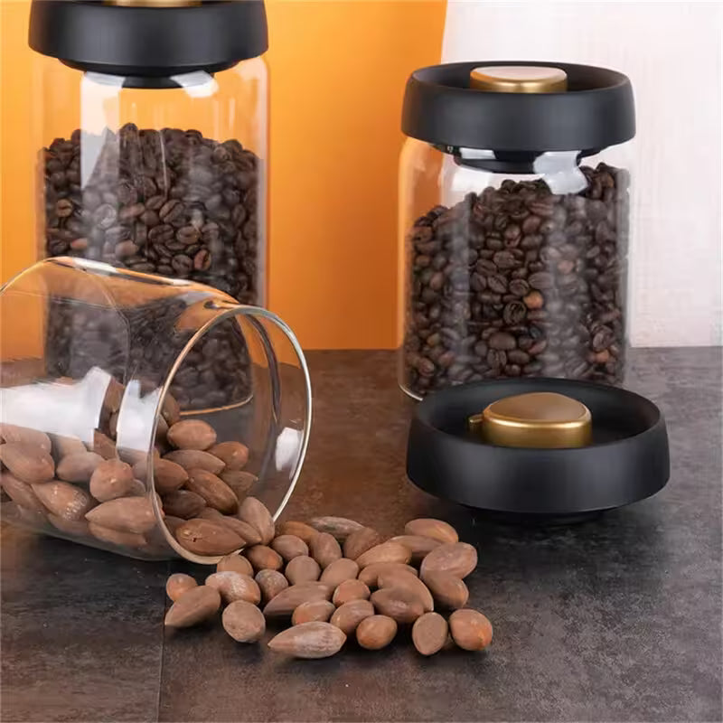 Glass containers with coffee beans and almonds on a countertop