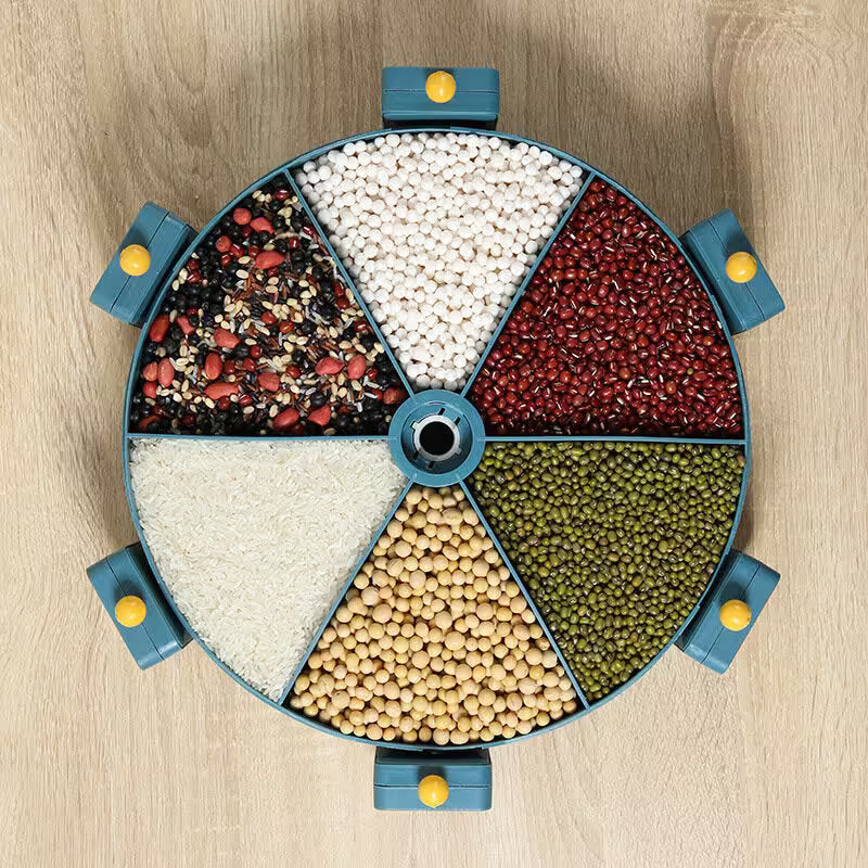 Round container with compartments filled with various types of grains and seeds on a wooden surface.