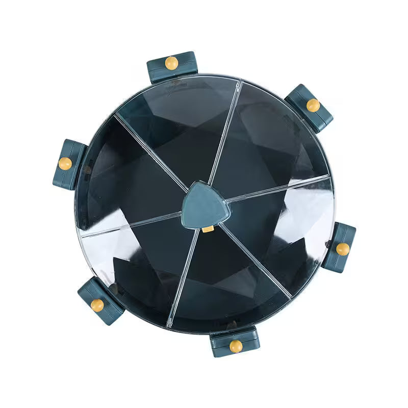 Round black object with metallic accents on a white background