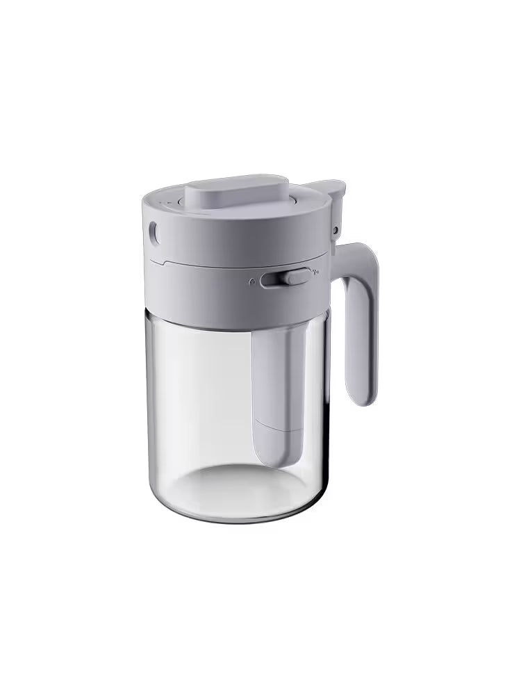 Clear glass pitcher with gray lid and handle on a white background