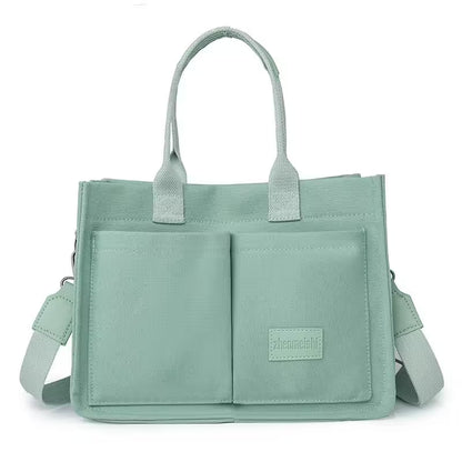 Light green handbag with a visible brand label on a white background