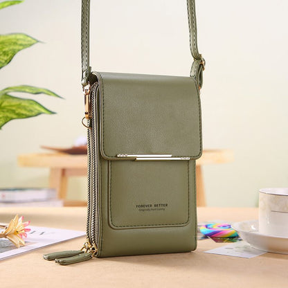 Green crossbody bag on a table with a blurred background