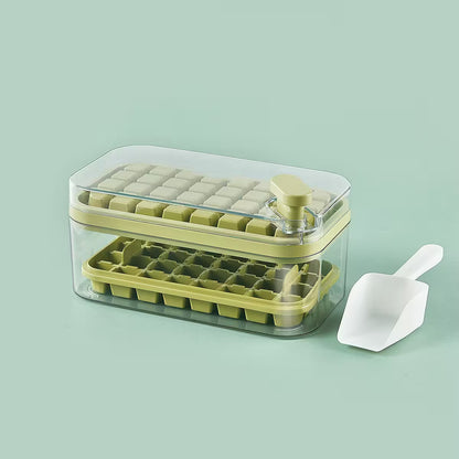 Green ice cube tray with clear lid and white scoop on a light green background