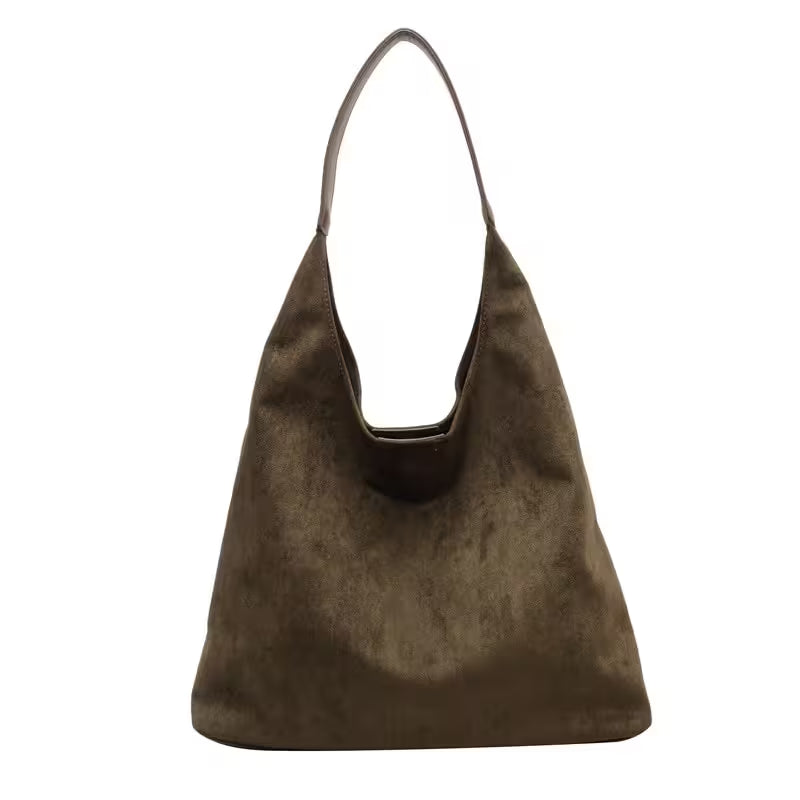 Brown suede handbag on a white background