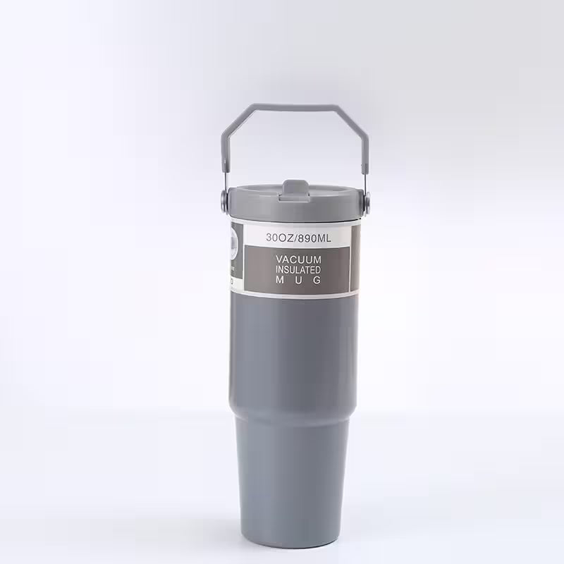 Gray vacuum insulated mug with a handle on a white background