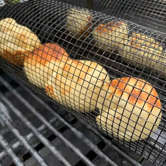 Mesh bag with potatoes on a grill