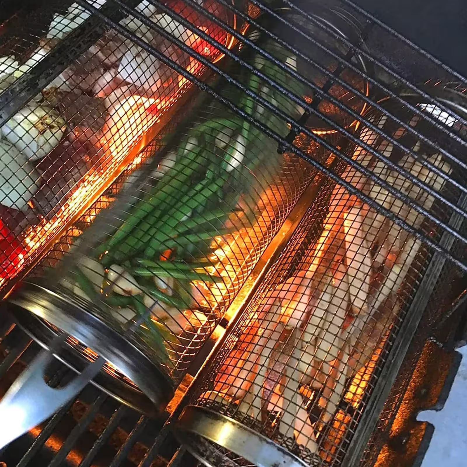 Close-up of a grill basket with vegetables being cooked over an open flame.