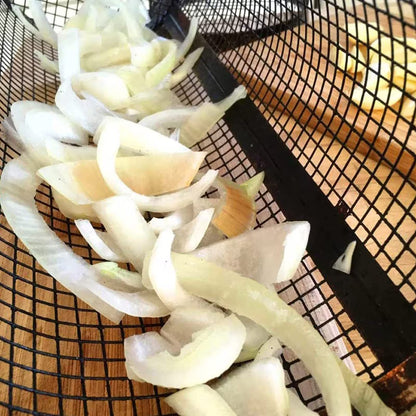 Sliced onions on a metal mesh tray