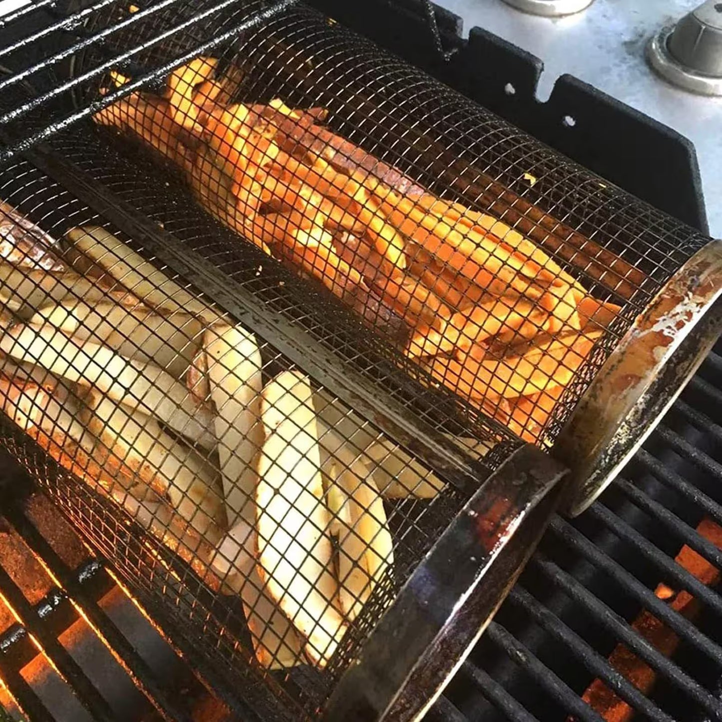 Fish fillets cooking in a grill basket over an open flame.