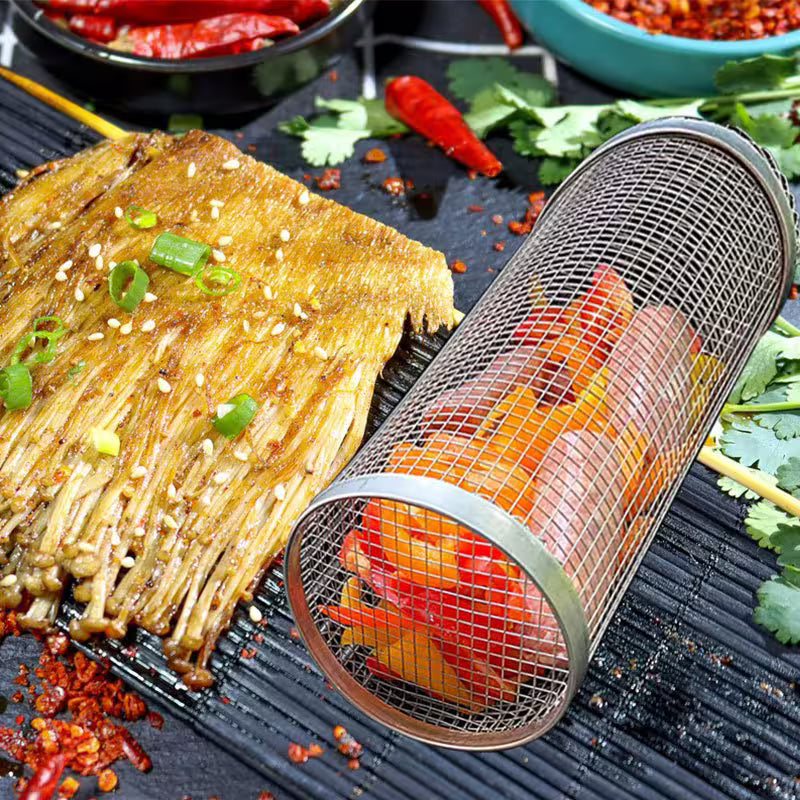 Grilled food with vegetables and a mesh basket on a grill