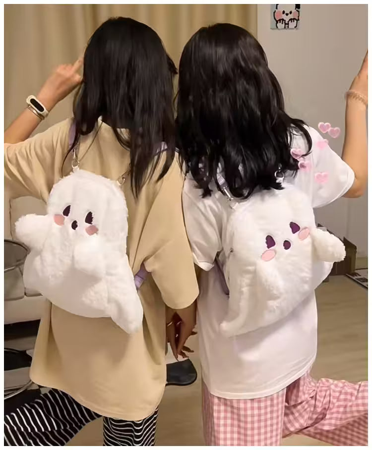 Two people wearing plush cloud-shaped backpacks with cartoon faces.