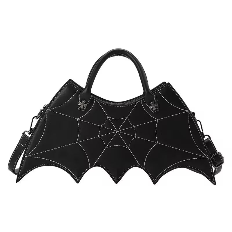 Black bat-shaped handbag with spider web design on a white background