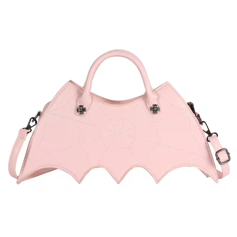 Pink bat-shaped handbag with decorative elements on a white background