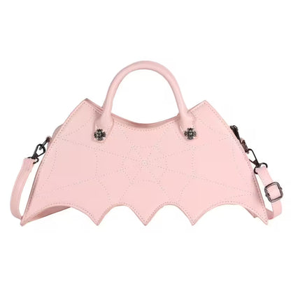 Pink bat-shaped handbag with decorative elements on a white background