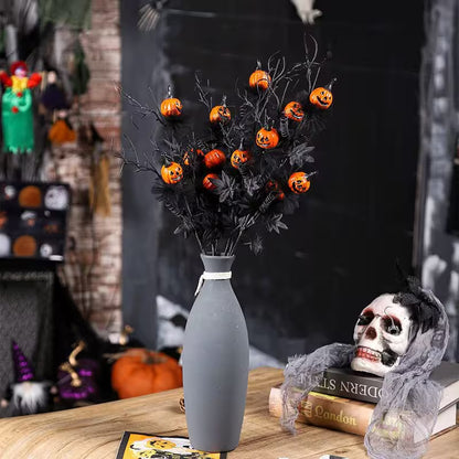 Halloween-themed decoration with black vase, pumpkins, and skeleton figure on a table.