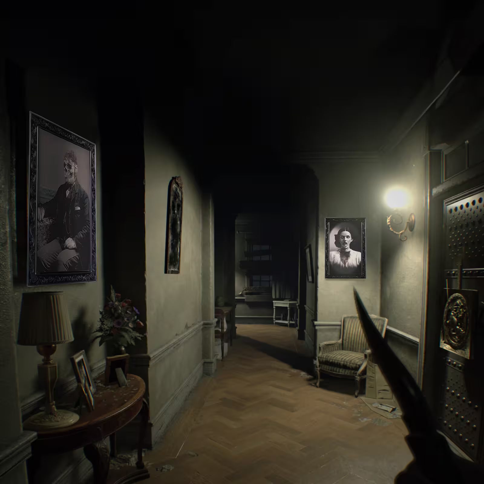 Dark hallway with vintage decor, including framed pictures and a chair.