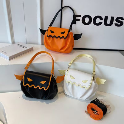 Three Halloween-themed handbags in orange, black, and white on a white surface with 'FOCUS' in the background.