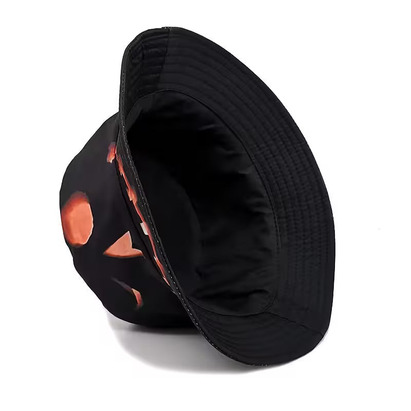 Black bucket hat with pumpkin design on a white background