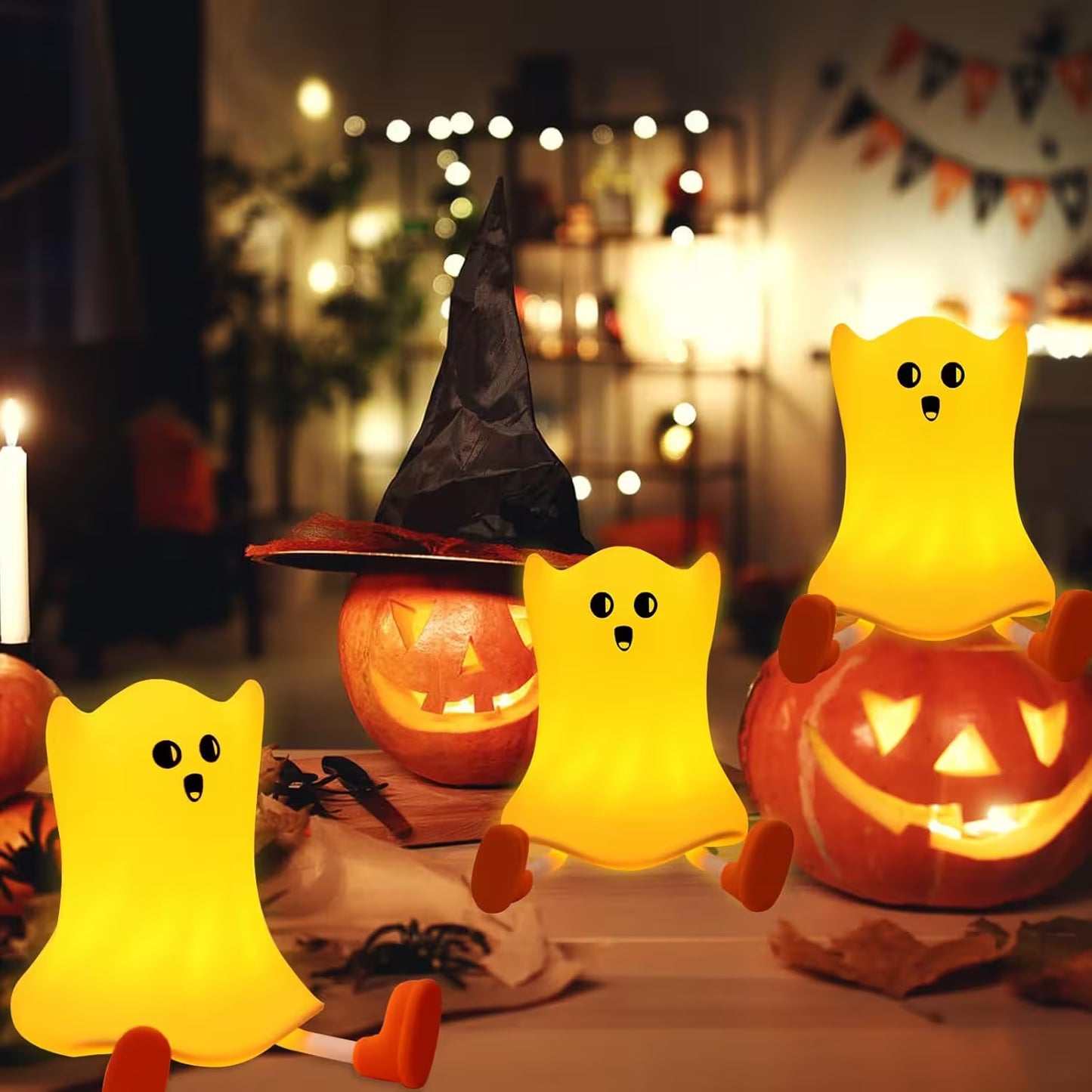 Halloween-themed decor with glowing ghost lamps and jack-o'-lanterns.