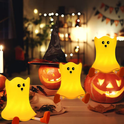 Halloween-themed decor with glowing ghost lamps and jack-o'-lanterns.
