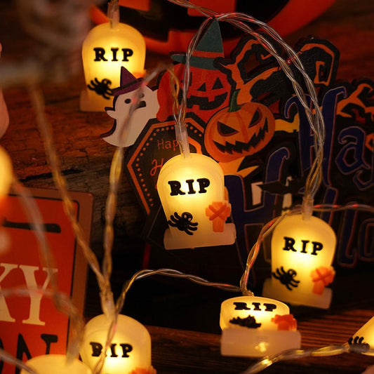 Halloween-themed string lights with 'RIP' tombstone design on a decorative background.