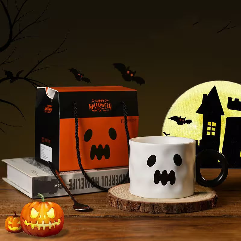 Halloween-themed mug with ghost design, pumpkin, and haunted house light in a dark setting.
