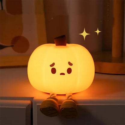 Cute pumpkin-shaped night light with a face on a shelf.