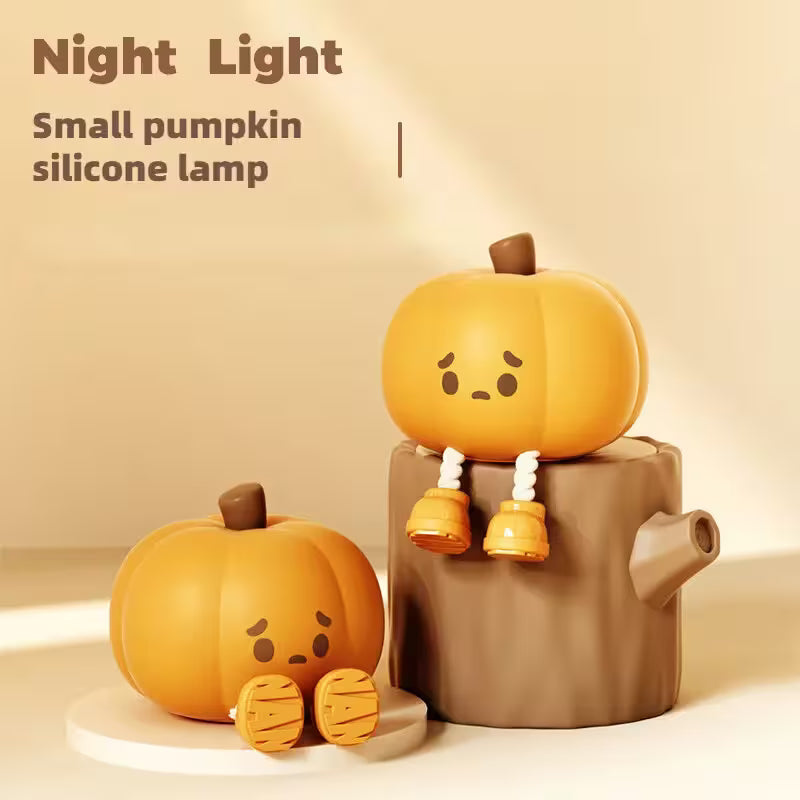 Small pumpkin silicone lamp with a smiling face on a beige background