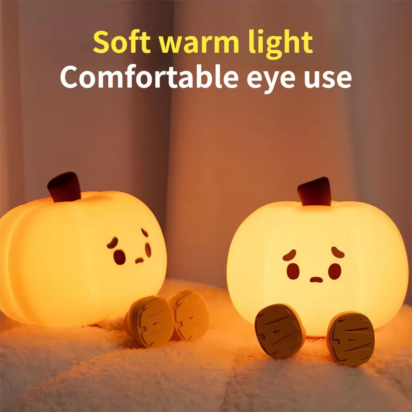 Two pumpkin-shaped night lights emitting a soft warm light on a neutral background.