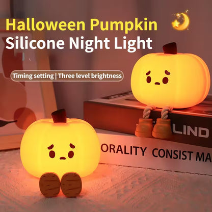 Halloween pumpkin silicone night light with a soft glow on a surface.