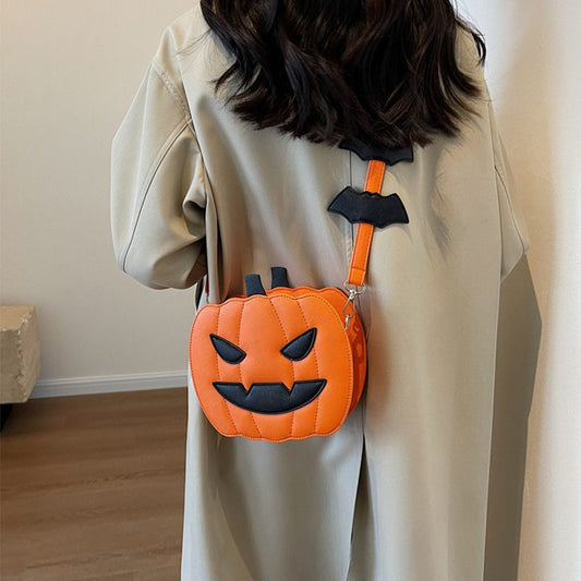 Person wearing a Halloween-themed pumpkin bag with bat decorations.