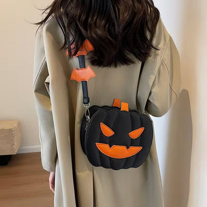 Person wearing a beige coat with a Halloween-themed black and orange pumpkin bag.