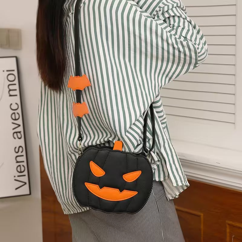 Person wearing a green and white striped shirt with a black Halloween-themed purse featuring orange accents.