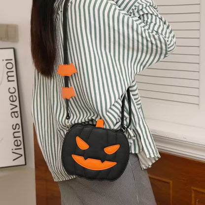 Person wearing a green and white striped shirt with a black Halloween-themed purse featuring orange accents.