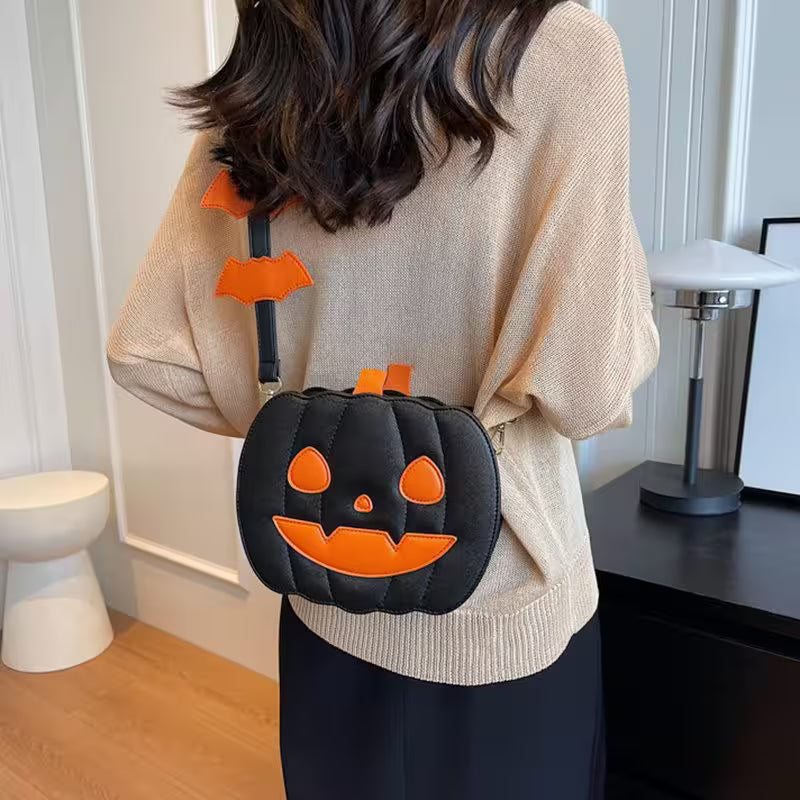 Person wearing a Halloween-themed black and orange pumpkin bag indoors.