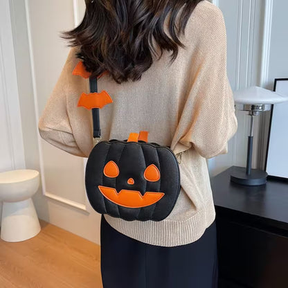 Person wearing a Halloween-themed black and orange pumpkin bag indoors.