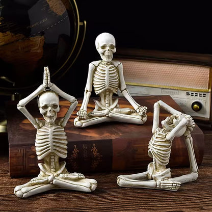 Three skeleton figurines in yoga poses on a wooden surface with a vintage radio in the background.