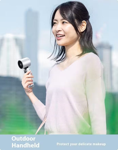 Woman holding an outdoor handheld device with a blurred background