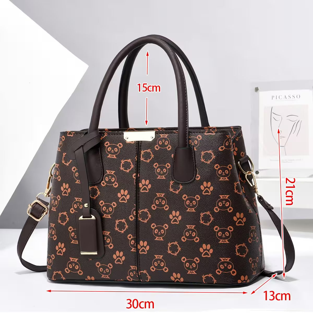 Brown handbag with panda and paw print pattern, shown with measurements on a white background.