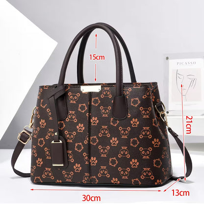 Brown handbag with panda and paw print pattern, shown with measurements on a white background.