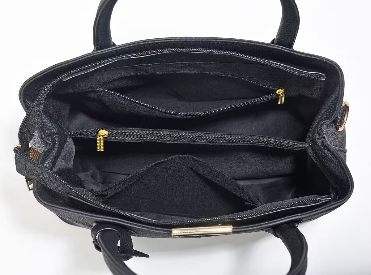Black handbag with gold zippers and accents on a white background