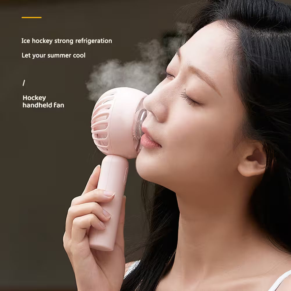 Woman using a pink handheld fan with text about ice hockey strong refrigeration.