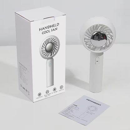 Handheld cool fan with packaging and user manual on a white background
