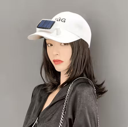 Person wearing a white cap with a solar panel and 'GG' logo on a gray background