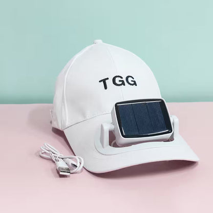 White cap with solar panel and USB cable on a pink surface with a light blue background