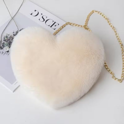 Fluffy white handbag with a gold chain on a light background