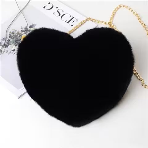 Black heart-shaped bag with a gold chain on a white background
