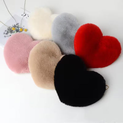 Set of heart-shaped and round plush toys in various colors on a white background.