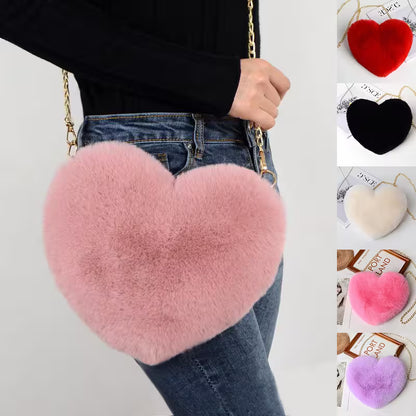 Heart-shaped pink fluffy bag held by a person, with additional heart-shaped fluffy items displayed.
