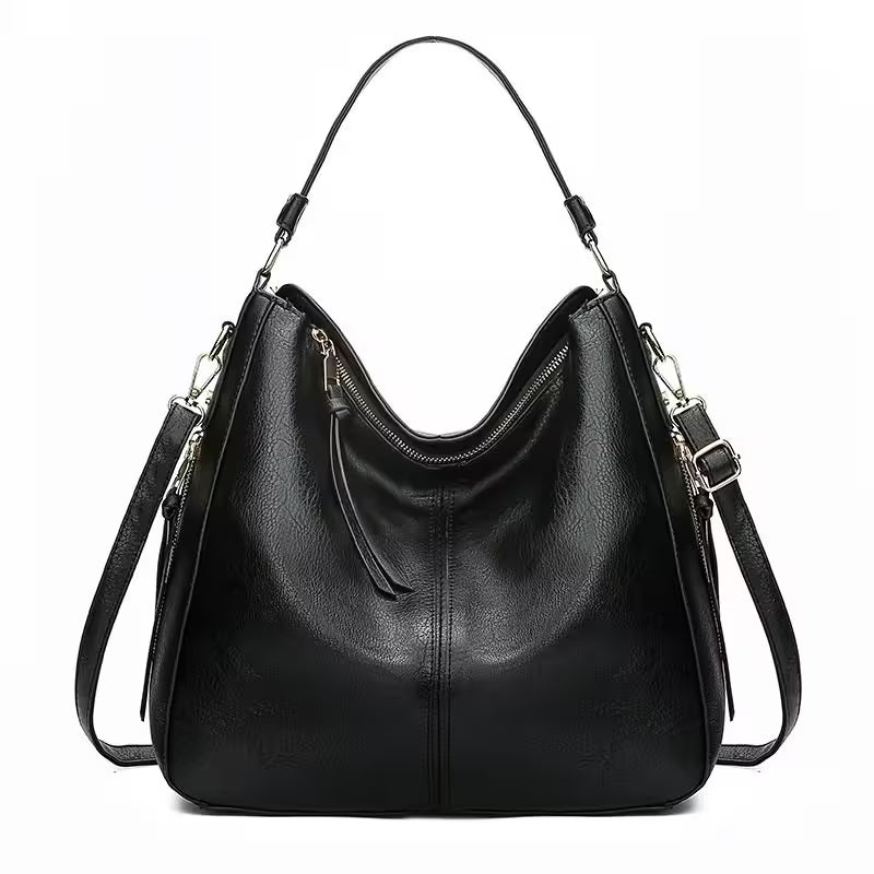 Black leather handbag with shoulder straps on a white background